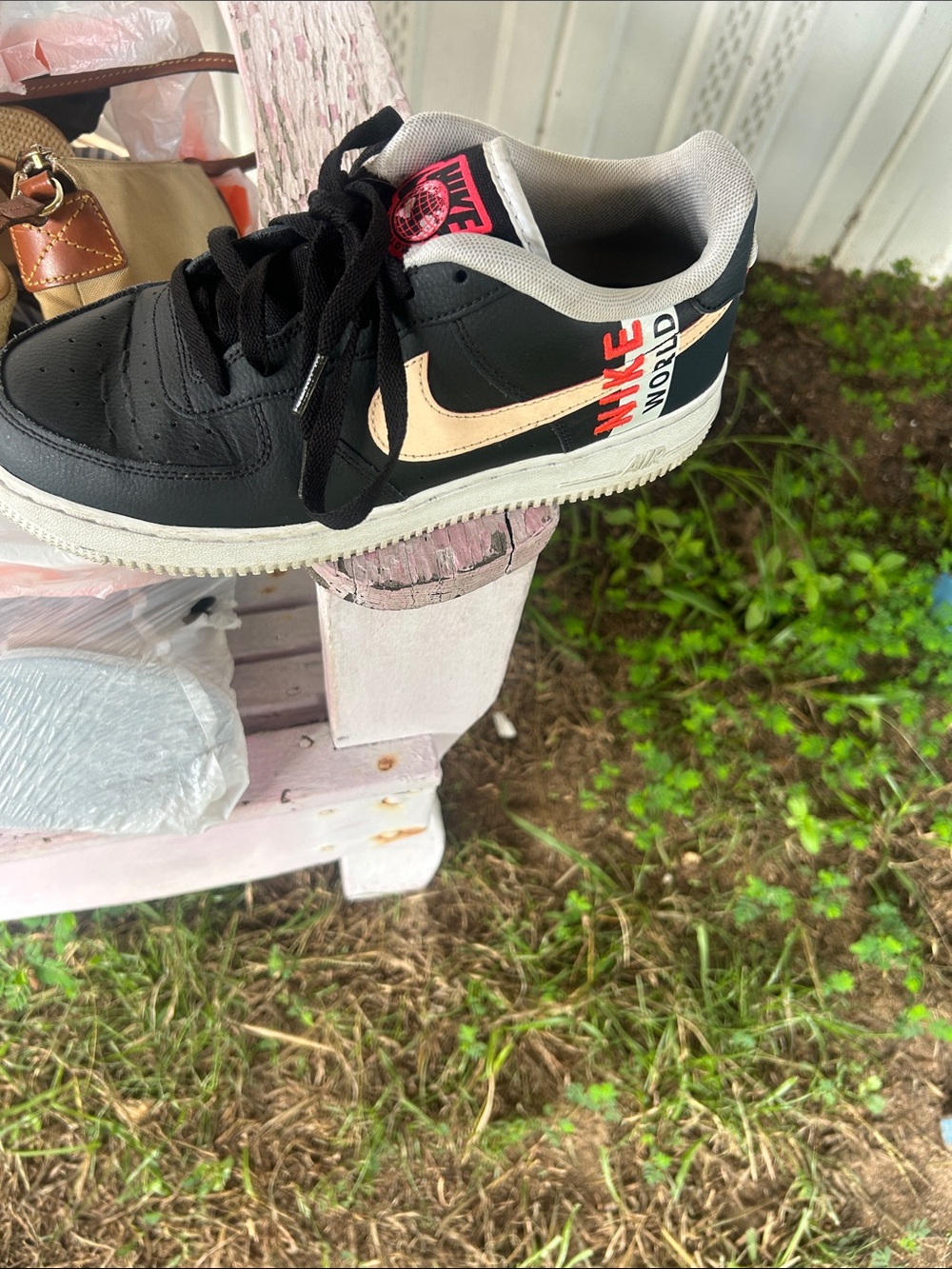 Nike Black Low-Top Sneaker with Cream Swoosh and Red Logo